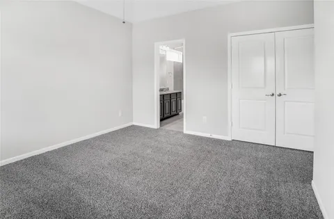 a bathroom with a granite countertop tub sink and mirror