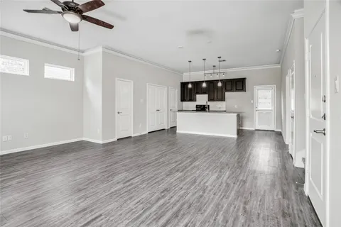 a kitchen with stainless steel appliances granite countertop a sink a stove and a wooden floors