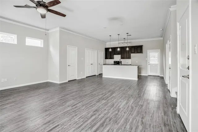 a kitchen with stainless steel appliances granite countertop a sink a stove and a wooden floors