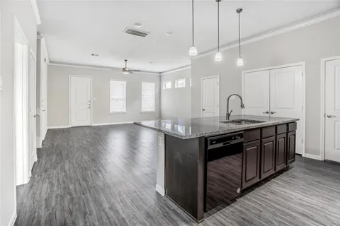 a kitchen with kitchen island white cabinets and wooden floor