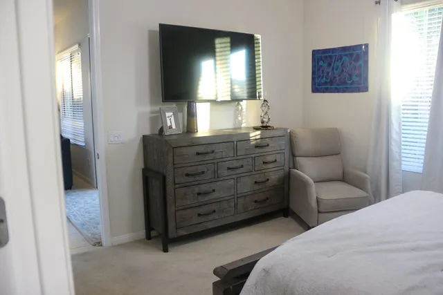 a bedroom with a bed and a television