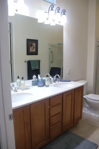 a bathroom with a double vanity sink and a mirror
