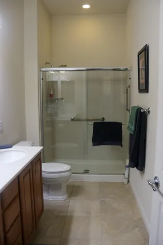 a bathroom with a sink a toilet and a shower