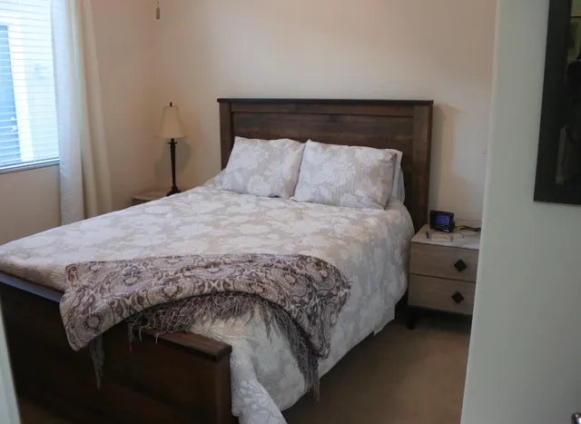 a bedroom with a bed and a window