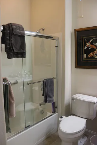 a bathroom with a toilet and a shower