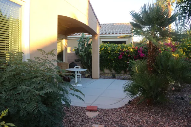 a view of a patio with table and chairs and potted plants