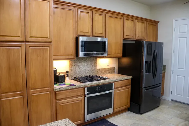 a kitchen with a refrigerator stove and microwave