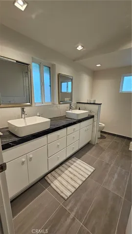 a bedroom with a bed and a mirror