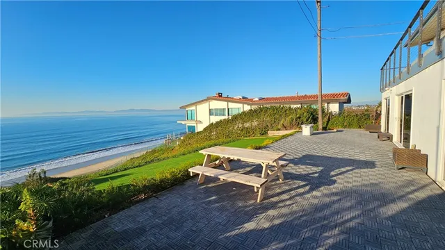 a view of a patio with a table and chairs