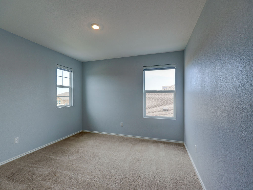 1716 Frontenac Street Leander, TX 78641 - Photo 26 of 34 an empty room with a window and windows