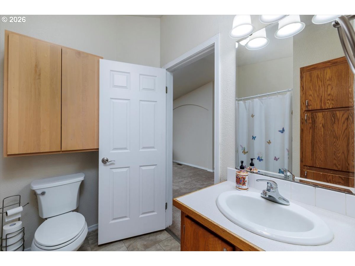2329 North Gray Street Cornelius, OR 97113 - Photo 12 of 27 a bathroom with a sink a toilet and mirror