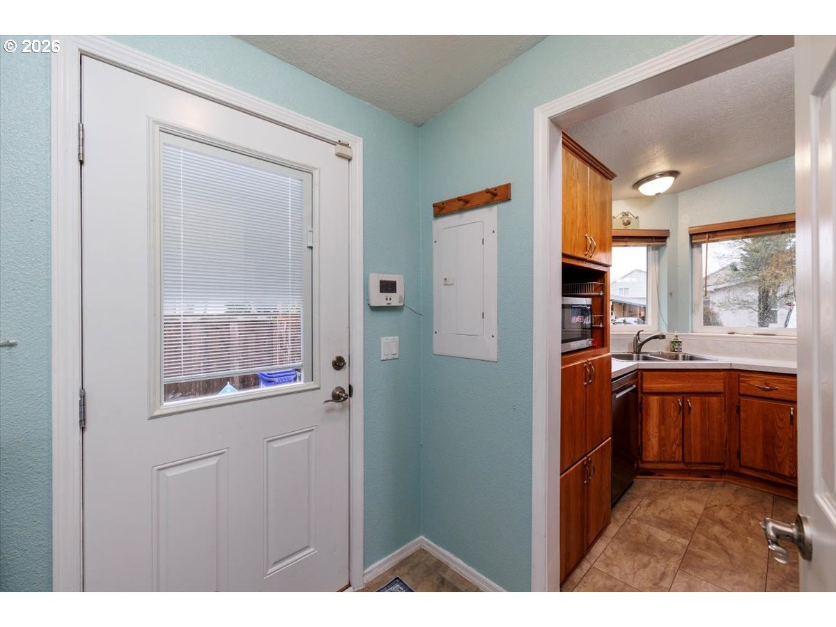 2329 North Gray Street Cornelius, OR 97113 - Photo 20 of 27 a kitchen with stainless steel appliances granite countertop a refrigerator and a sink