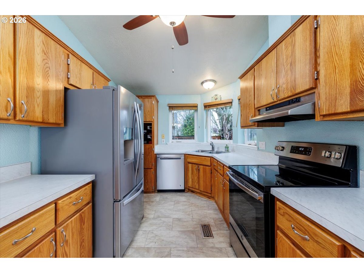 2329 North Gray Street Cornelius, OR 97113 - Photo 9 of 27 a kitchen with stainless steel appliances granite countertop a sink cabinets and a refrigerator
