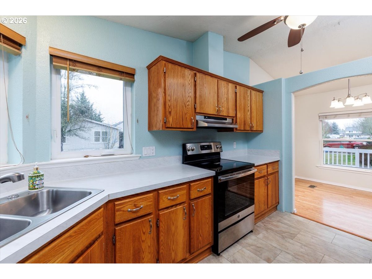 2329 North Gray Street Cornelius, OR 97113 - Photo 10 of 27 a kitchen with stainless steel appliances granite countertop a sink a stove and a microwave