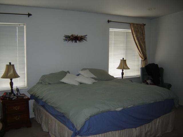 15240 Fisk Road Yakima, WA 98908 - Photo 8 of 13 a bed sitting in a bedroom next to a window