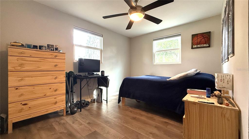 111 Palencia Road Auburndale, FL 33823 - Photo 12 of 28 a bedroom with a bed and wooden floor