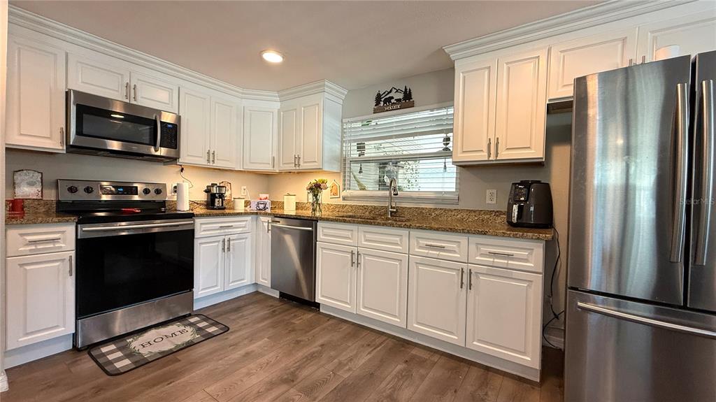 111 Palencia Road Auburndale, FL 33823 - Photo 16 of 28 a kitchen with a refrigerator stove and microwave