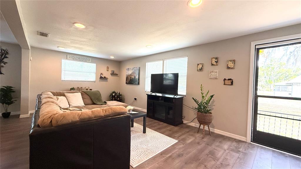 111 Palencia Road Auburndale, FL 33823 - Photo 18 of 28 a living room with furniture a flat screen tv and a window