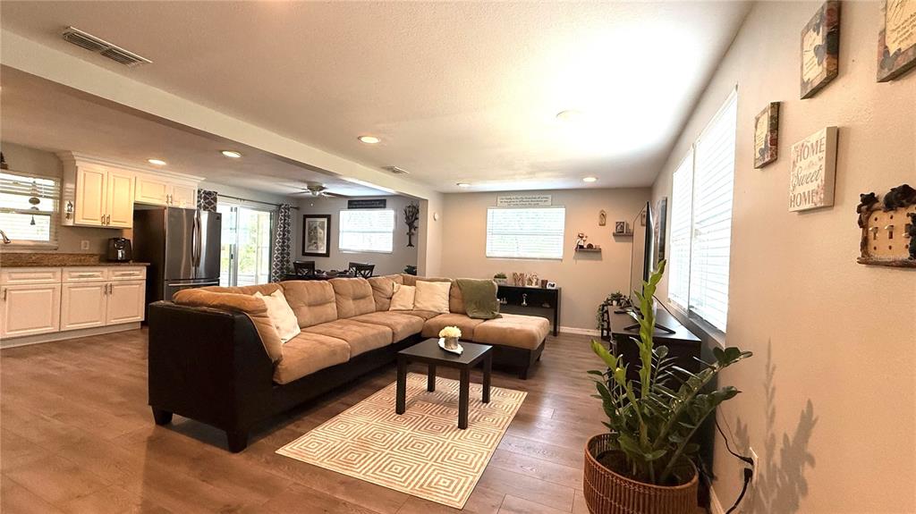 111 Palencia Road Auburndale, FL 33823 - Photo 6 of 28 a living room with furniture or couch and a kitchen