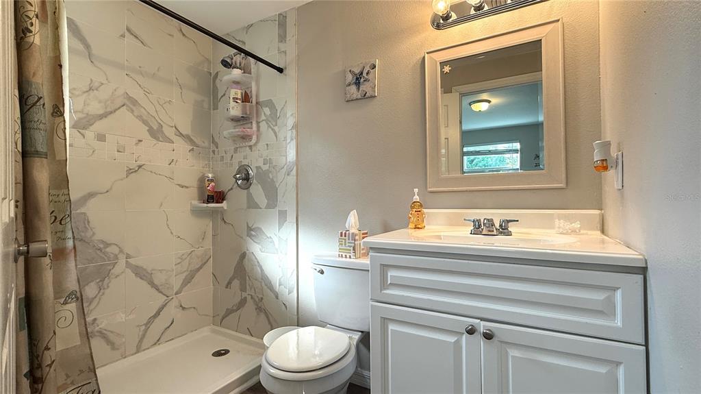 111 Palencia Road Auburndale, FL 33823 - Photo 7 of 28 a bathroom with a sink a toilet and shower