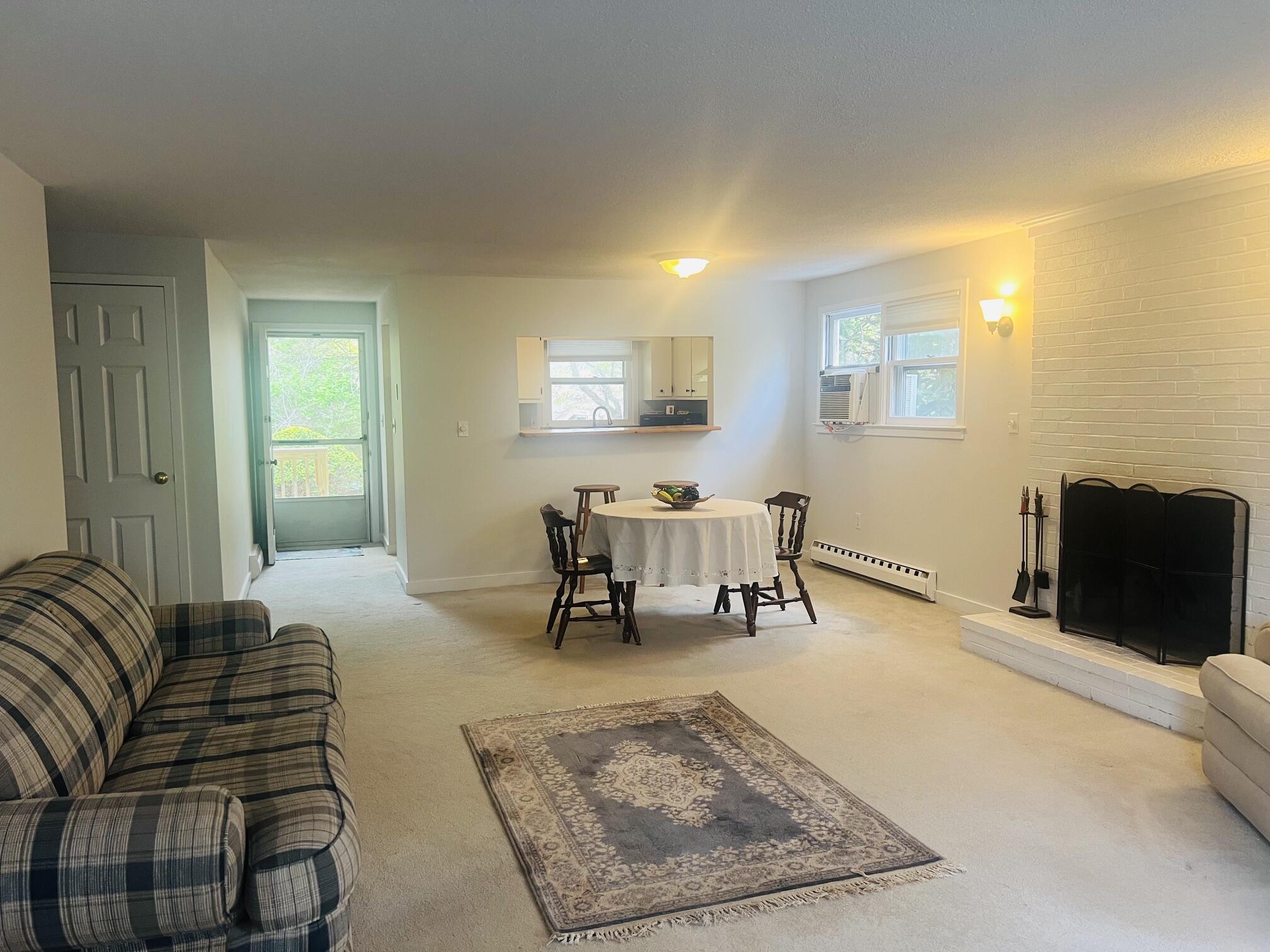 1431 Iyannough Road, Unit 1 Centerville, MA 02632 - Photo 4 of 28 a living room with furniture and a table