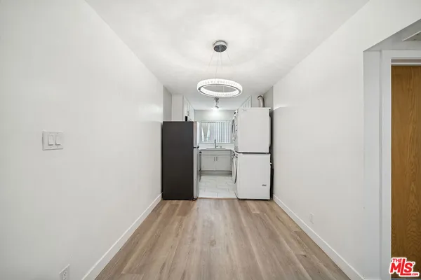 a view of a kitchen with a sink and wooden floor