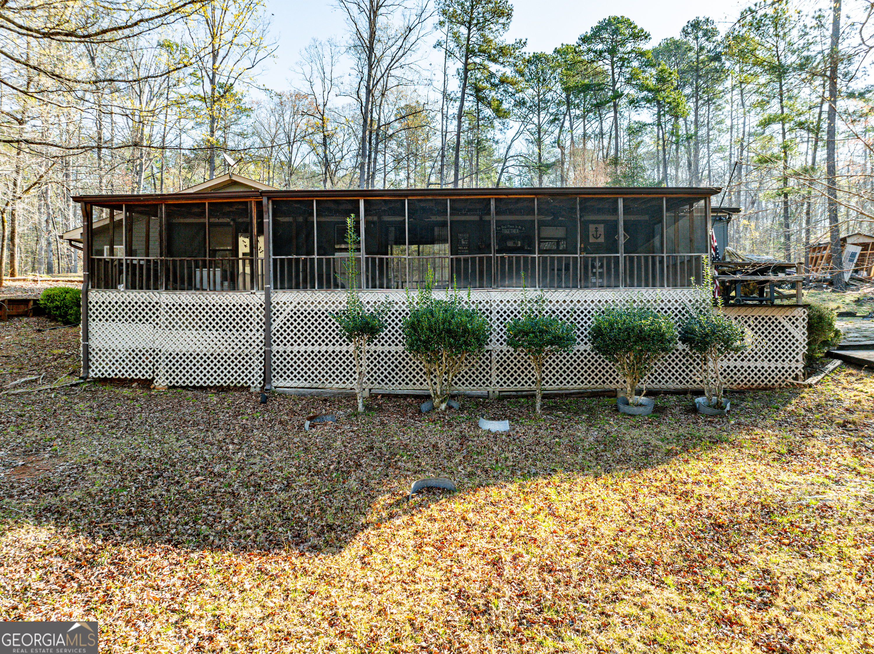 Lakeside of house with screened porch