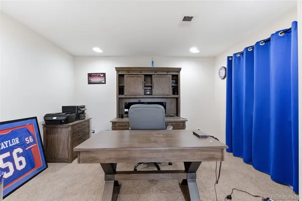 a kitchen with a table chairs refrigerator and stove
