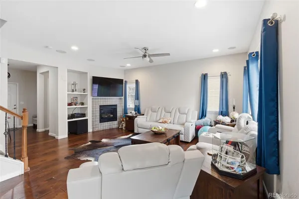 a living room with furniture fireplace and flat screen tv