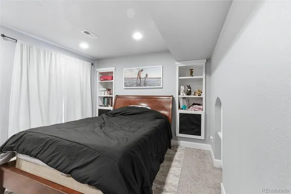 a bedroom with a bed and a cabinets
