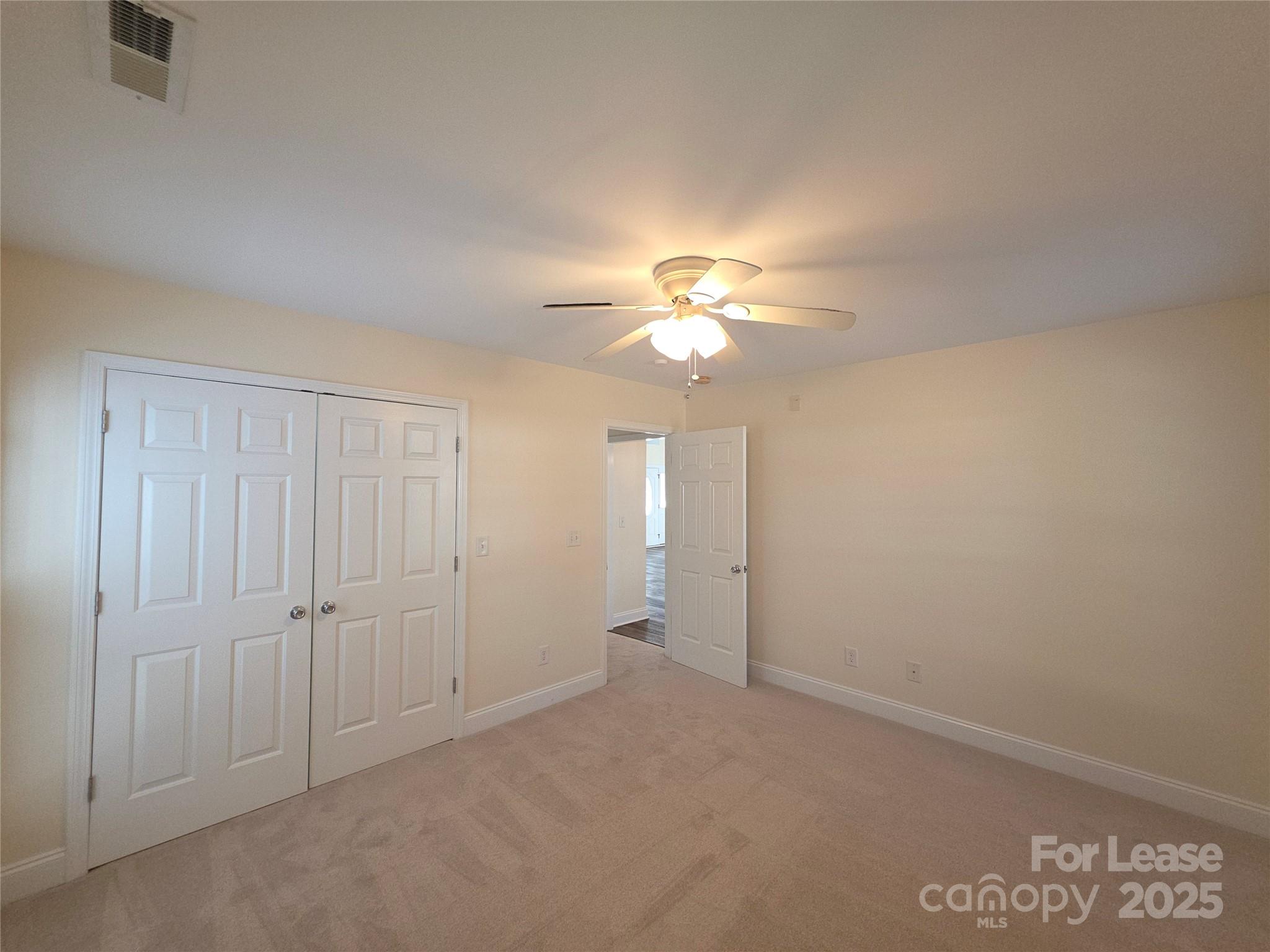 1682 Lane Road Mount Holly, NC 28120 - Photo 16 of 32 an empty room with chandelier fan