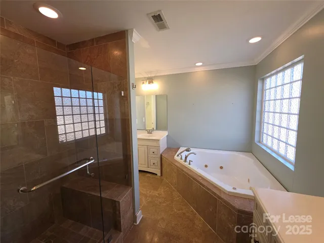 a bathroom with a bathtub and a shower