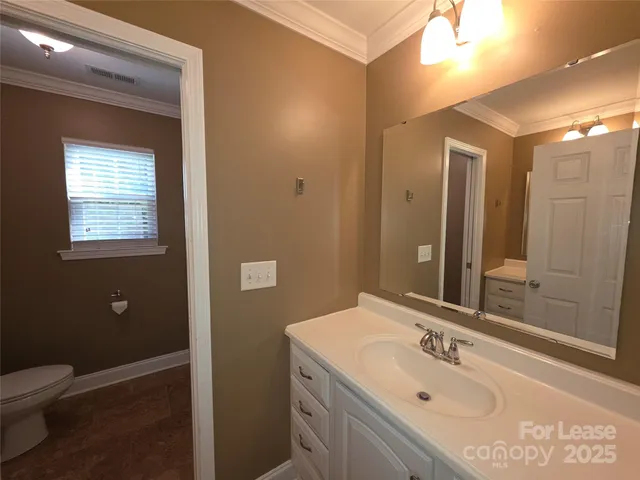 a bathroom with a sink toilet and mirror