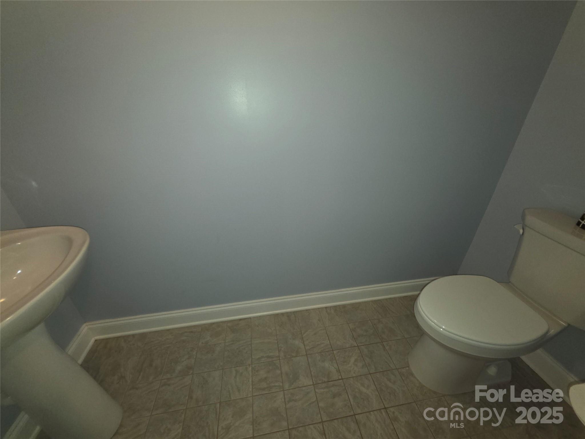 1682 Lane Road Mount Holly, NC 28120 - Photo 24 of 32 a bathroom with a toilet and a sink