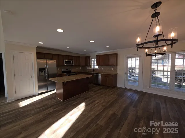 a large kitchen with lots of counter space a sink and appliances