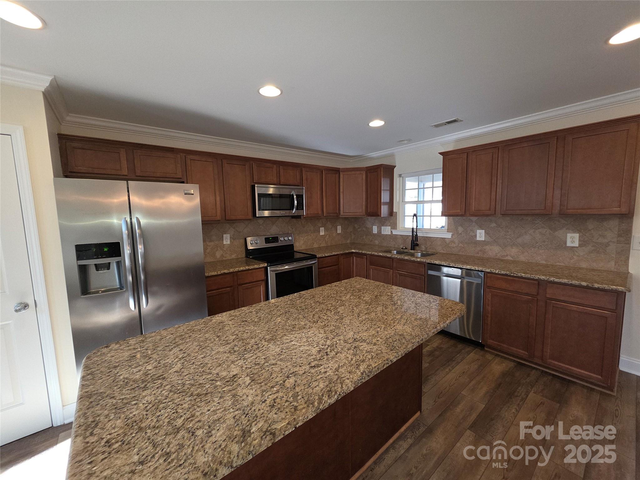 1682 Lane Road Mount Holly, NC 28120 - Photo 7 of 32 a kitchen with stainless steel appliances granite countertop a refrigerator a sink a stove a microwave and wooden cabinets