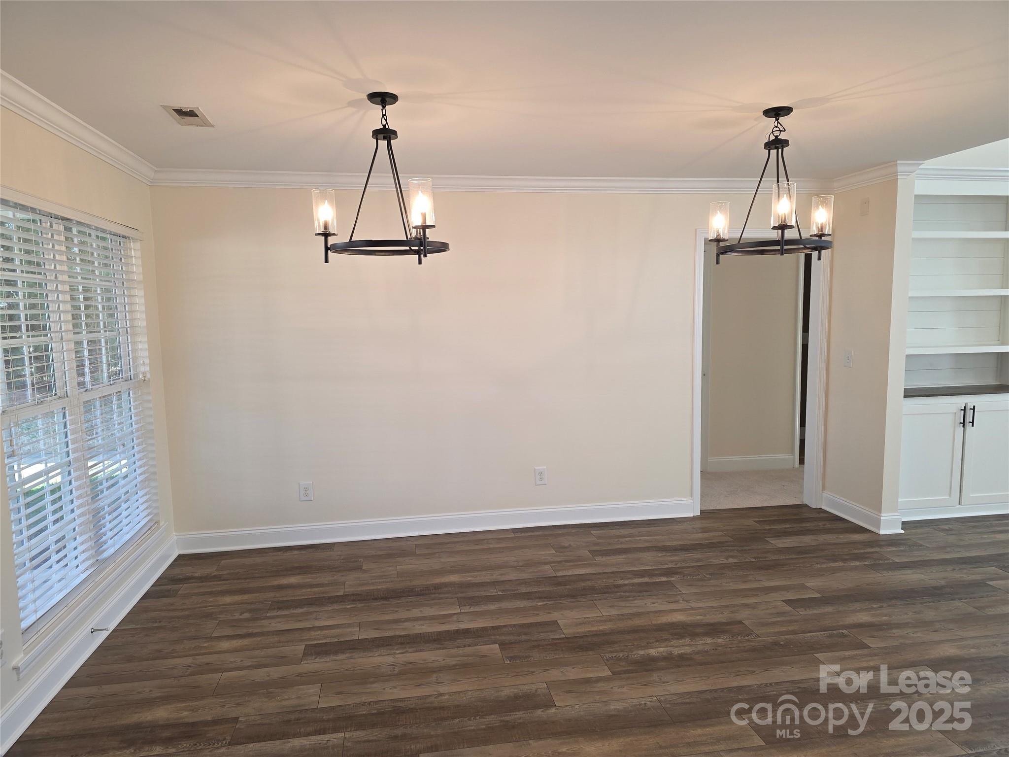 1682 Lane Road Mount Holly, NC 28120 - Photo 9 of 32 a view of a room with wooden floor window and a chandelier