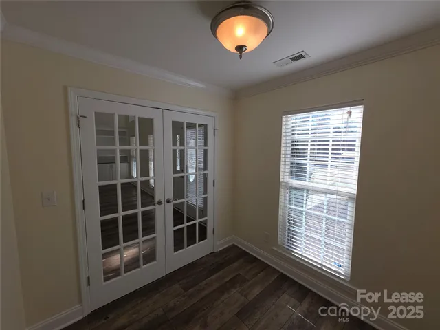 a view of wooden floor and windows in a room