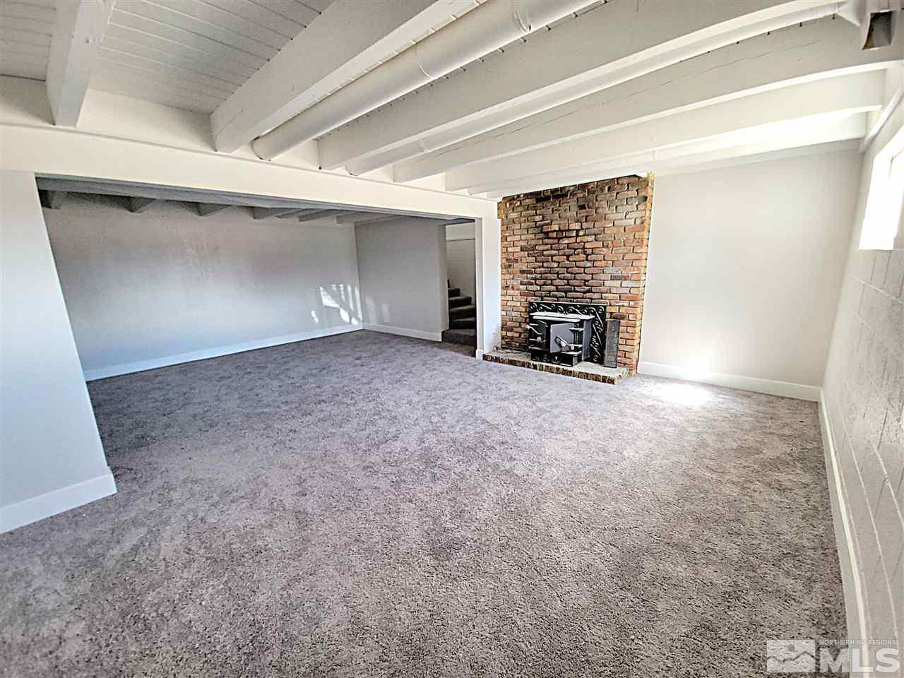 1901 Carlin Street Reno, NV 89503 - Photo 3 of 10 an empty room with fireplace and windows
