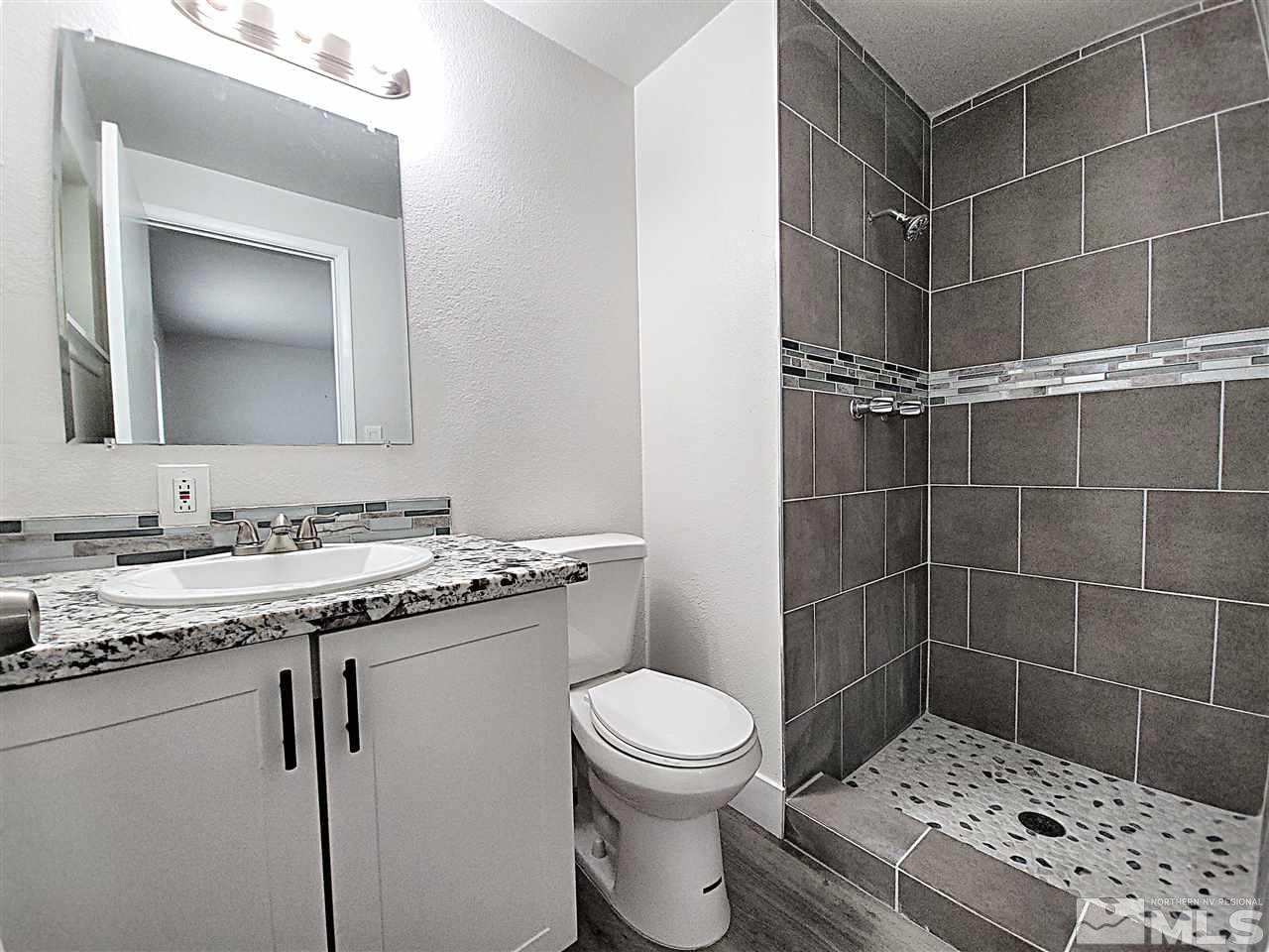 1901 Carlin Street Reno, NV 89503 - Photo 4 of 10 a bathroom with a sink a toilet and shower