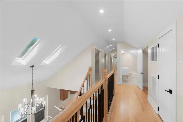 a view of entryway and hall with wooden floor