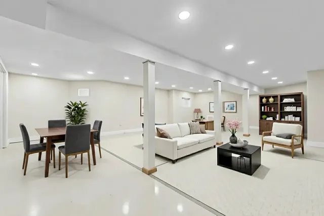 a living room with furniture and a dining table with kitchen view