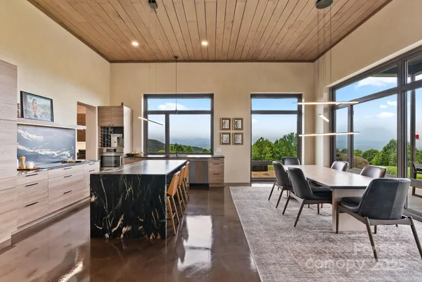 a dining room with furniture window and wooden floor