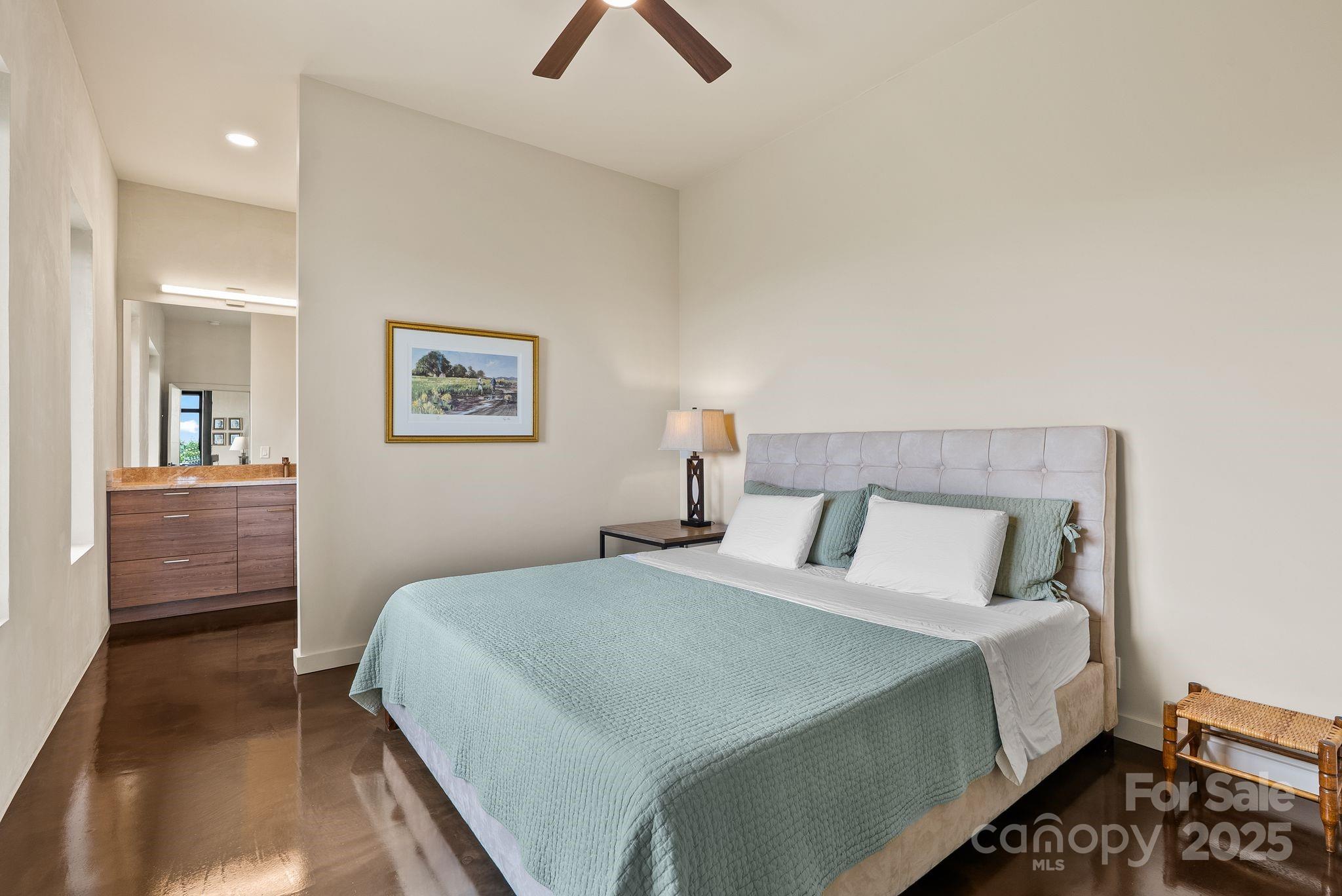 1045 Graham Road Marshall, NC 28753 - Photo 14 of 48 a bedroom with a bed and a chandelier