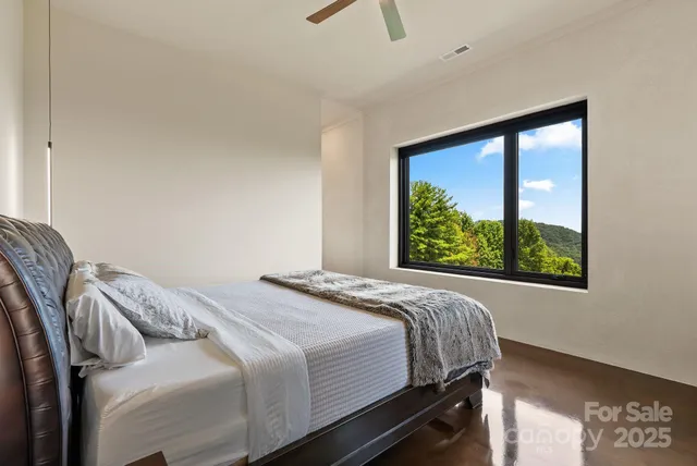 a bed sitting in a bedroom next to a window