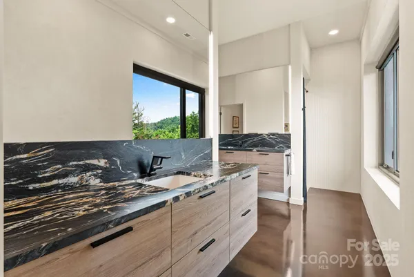 a kitchen with a stove and white cabinets