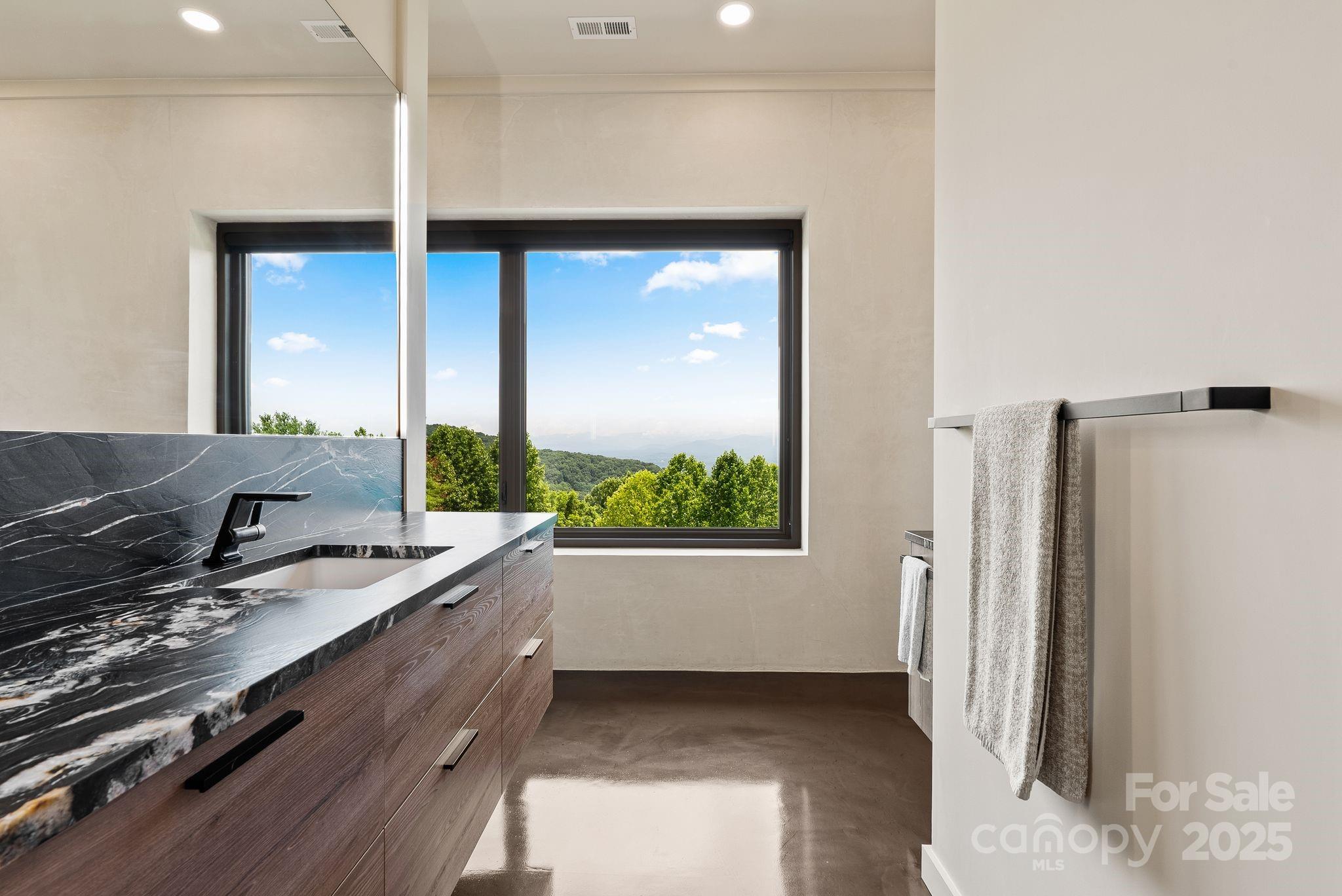 1045 Graham Road Marshall, NC 28753 - Photo 18 of 48 a bathroom with a granite countertop sink and a large mirror