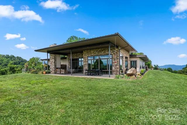a view of a house with porch and garden