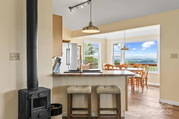 a kitchen with a sink and chairs
