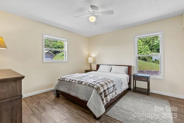 a bedroom with a bed lamp and a window